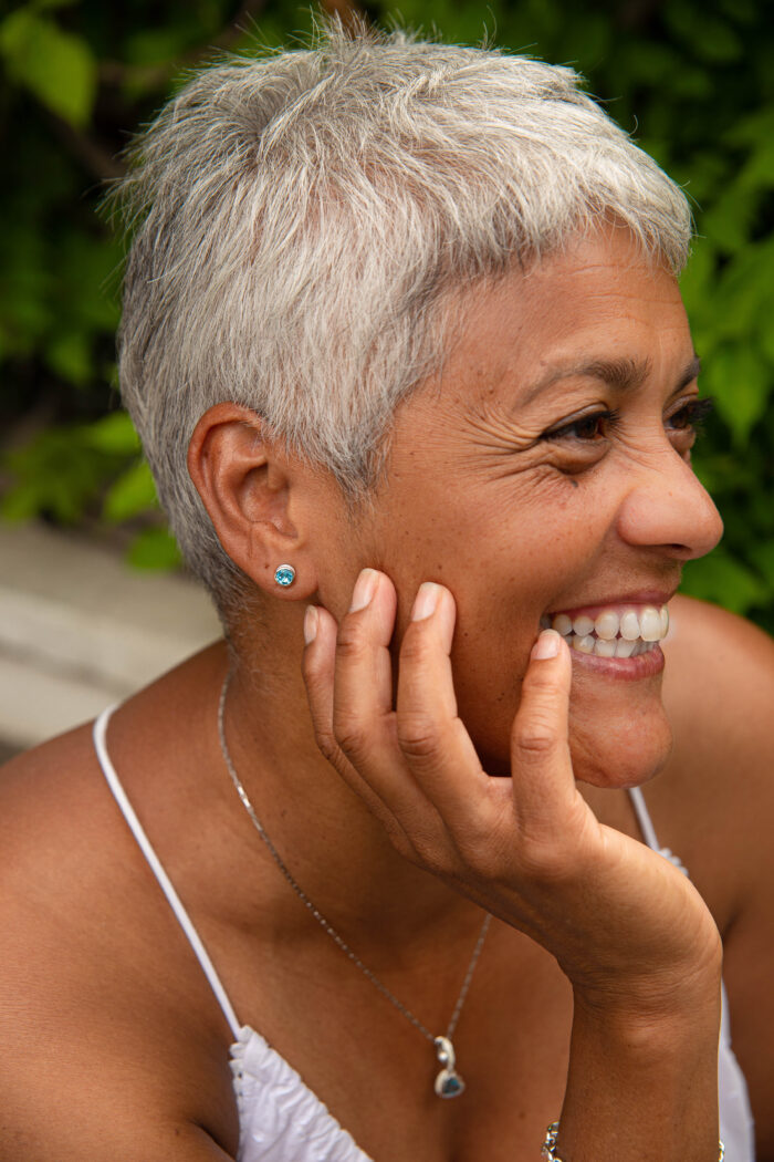 ‘Play by ear’ stud earrings with a pair of round Ostro Blue topaz set in Sterling Silver wearing and our ‘Tradition with a twist’ charm with a heart Ostro Blue Topaz set in Sterling Silver being worn on a silver necklace