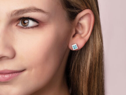 ‘Play by ear’ stud earrings with a pair of square Ostro Blue topaz set in Sterling Silver being worn by model