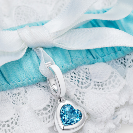 closeup of blue and white garter with heart blue topaz charm