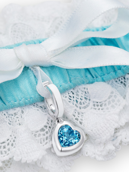 closeup of blue and white garter with heart blue topaz charm