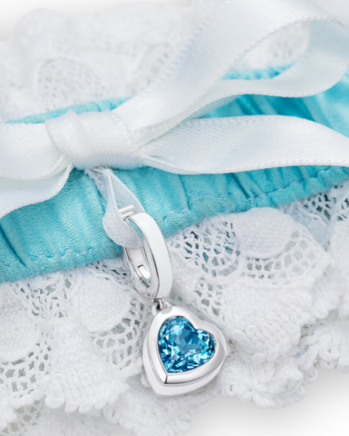 closeup of blue and white garter with heart blue topaz charm