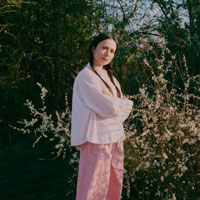 Lela Boxy Shirt in pink and orange, worn with Amelia Wide Leg Trousers in pink cotton corduroy, by Saywood. Made in the UK.