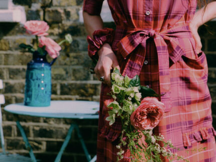 Rosa red tartan puff sleeve shirtdress with tie belt and ruffled pockets, lifestyle styling by Saywood