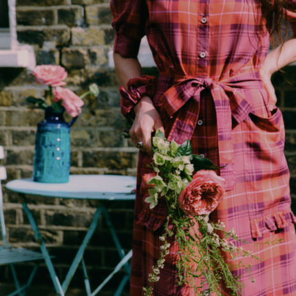 Rosa red tartan puff sleeve shirtdress with tie belt and ruffled pockets, lifestyle styling by Saywood