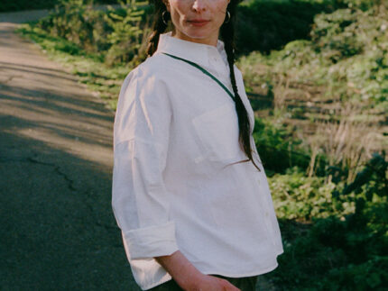 Styling inspiration: Lela white recycled cotton shirt paired with khaki Amelia wide leg trousers, outdoor lifestyle shot by Saywood