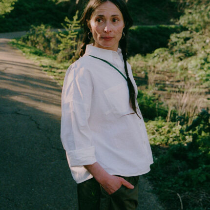 Styling inspiration: Lela white recycled cotton shirt paired with khaki Amelia wide leg trousers, outdoor lifestyle shot by Saywood