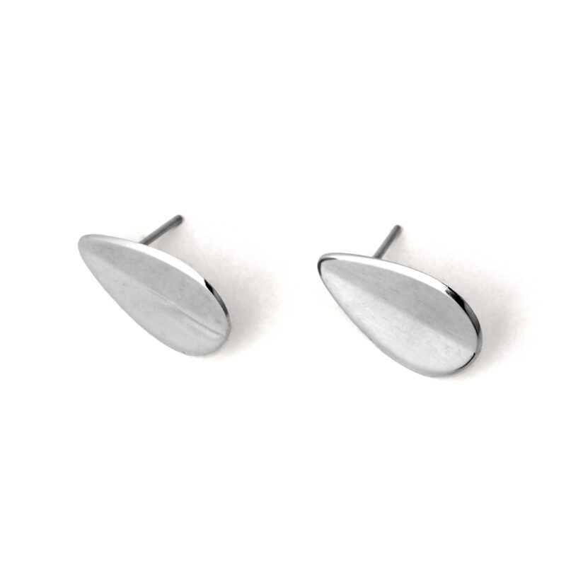 A pair of silver-colored teardrop-shaped earrings with a folded concavity design, displayed against a white background.