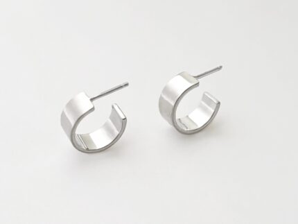 Pair of silver hoop earrings on a light gray background