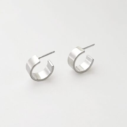 Pair of silver hoop earrings on a light gray background