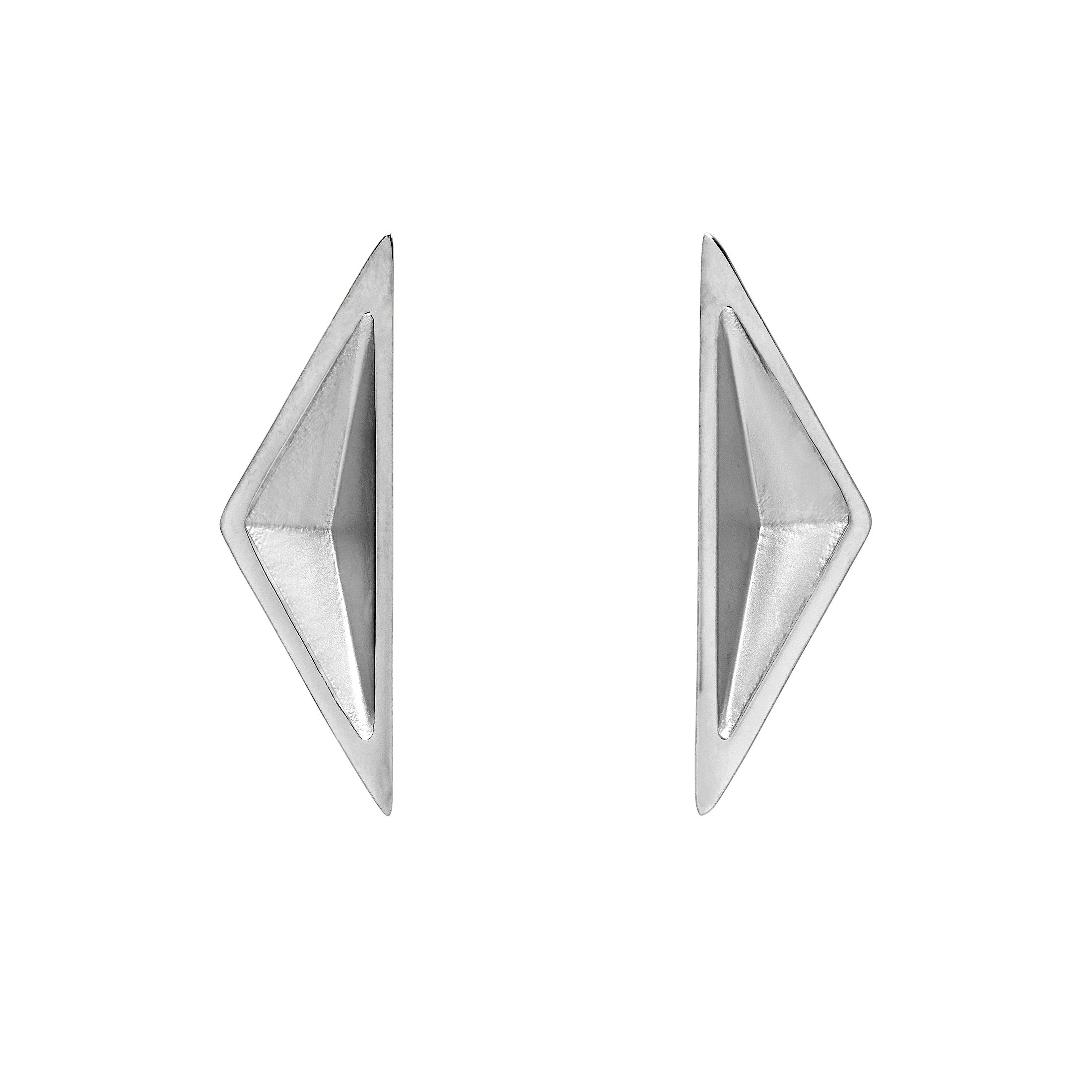 Pair of geometric silver earrings on a white background