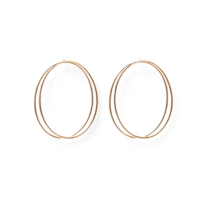 A pair of thin, oval-shaped earrings with a silver finish, displayed against a white background.