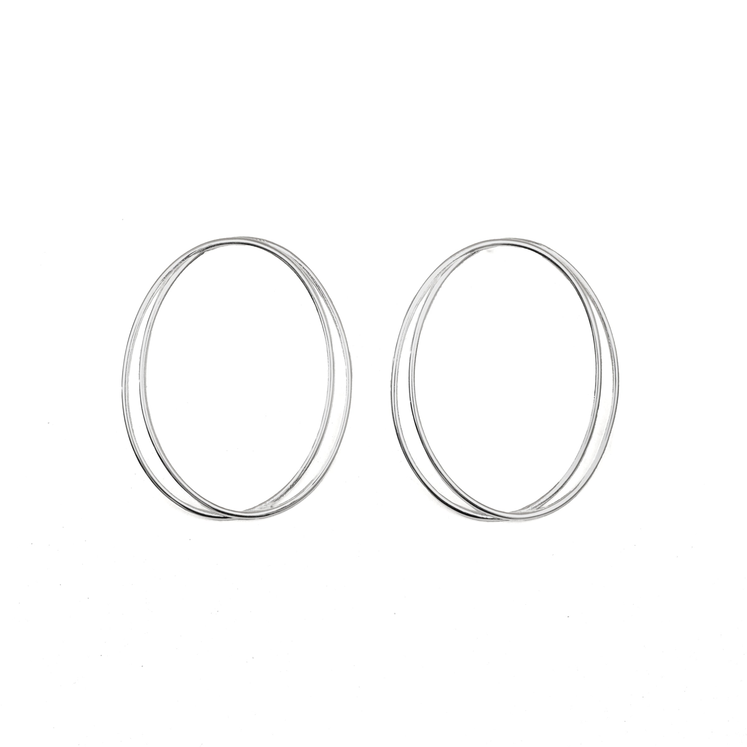 A pair of thin, oval-shaped earrings with a silver finish, displayed against a white background.