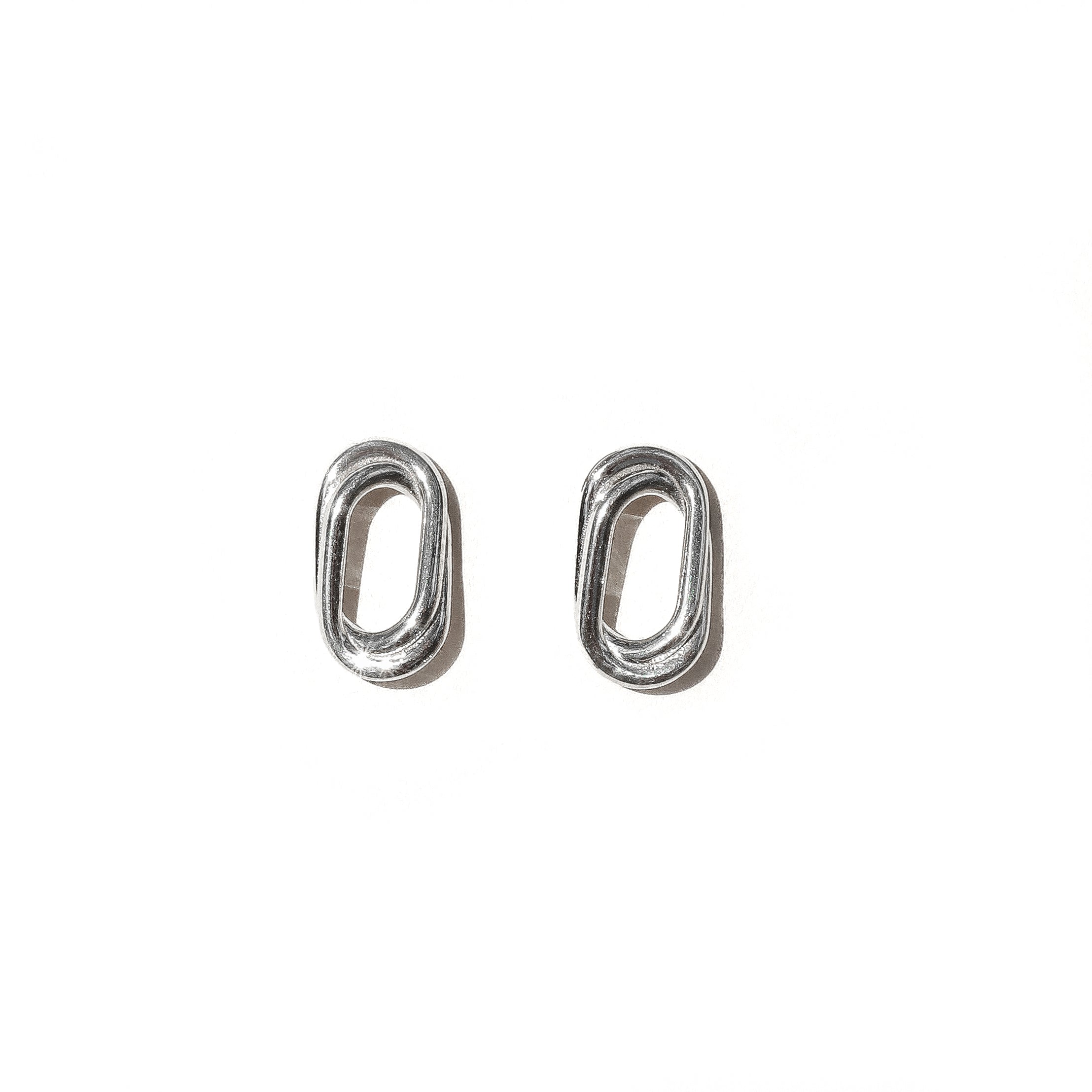 A pair of silver double oval earrings on a white background
