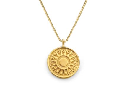 Gold necklace with a round pendant on a white background