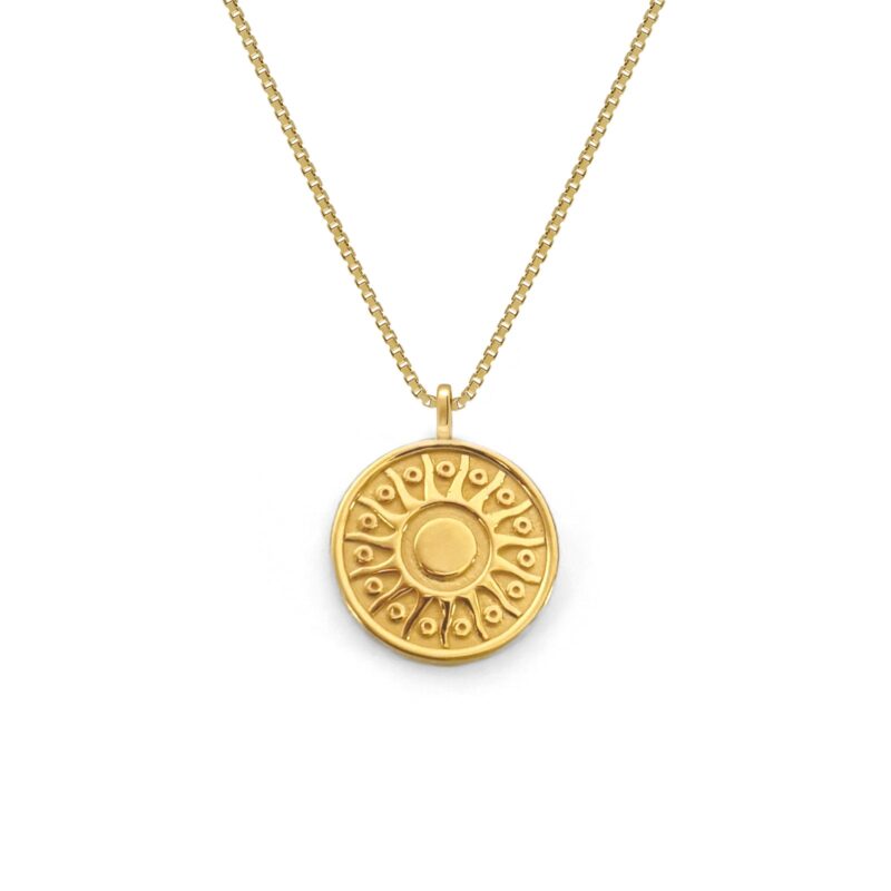 Gold necklace with a round pendant on a white background