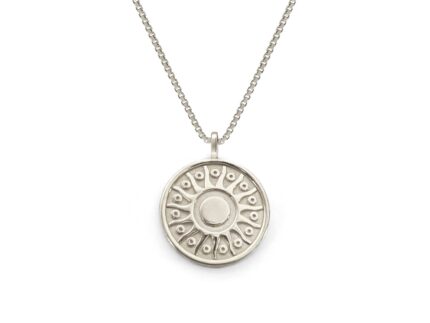 Silver necklace with a round pendant on a white background