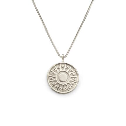 Silver necklace with a round pendant on a white background