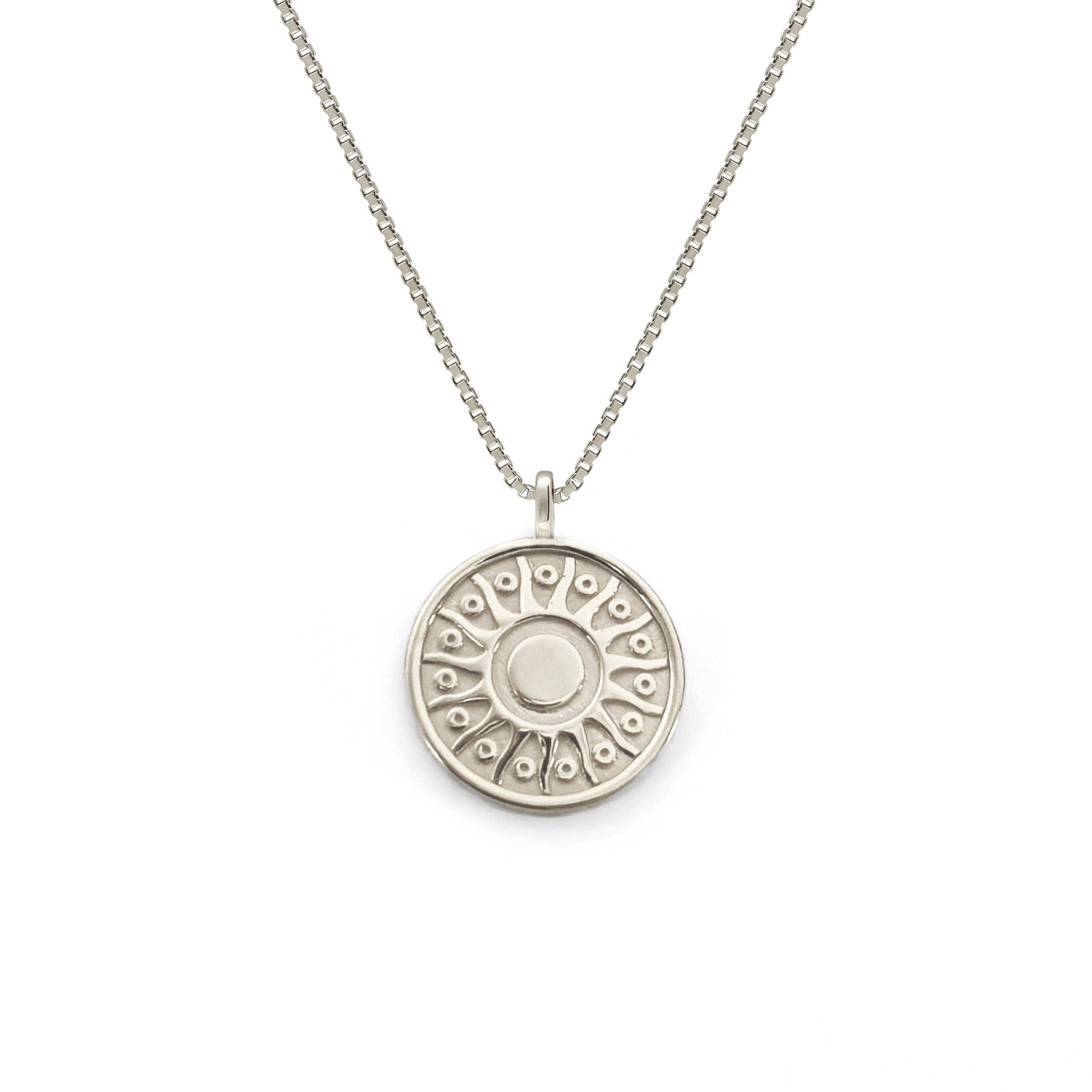 Silver necklace with a round pendant on a white background