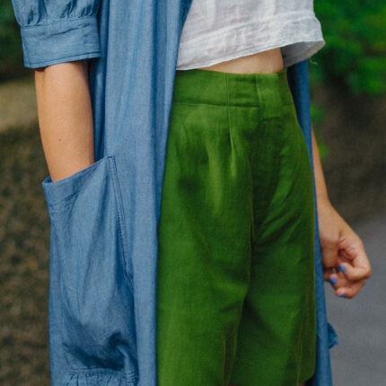 Detail of Bessie tailored shorts waist and pocket in rich olive green deadstock linen cotton by Saywood