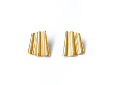 Pair of gold earrings on a white background