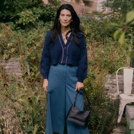 Frida midnight navy cardigan styled with denim wide leg trousers, full length lifestyle shot, Scottish-spun lambswool